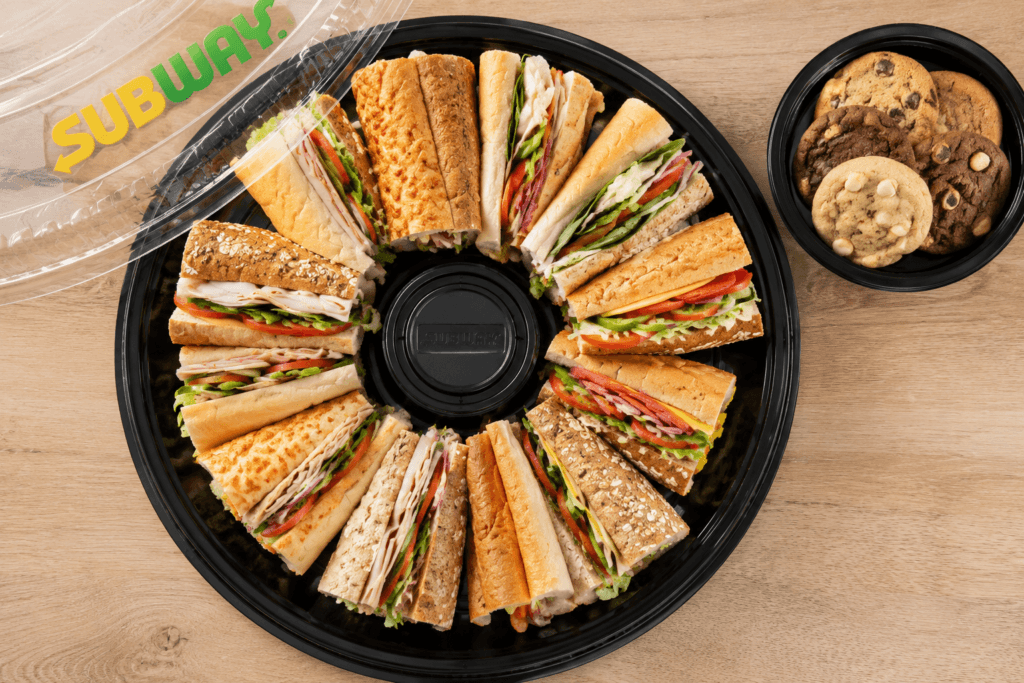 Subway sandwich platter with assorted halved subs and cookies for a group order